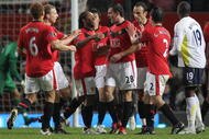 MANCHESTER, ENGLAND - DECEMBER 01:  Darron Gibson of Manchester United is congratulated by his team mates after scoring the opening goal during the Carling Cup Quarter Final match between Manchester United and Tottenham Hotspur at Old Trafford on December 1, 2009 in Manchester, England.  (Photo by Alex Livesey/Getty Images)
