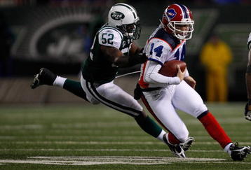 EAST RUTHERFORD, NJ - OCTOBER 18: Ryan Fitzpatrick #14 of the Buffalo Bills runs out of the pocket from David Harris #52 of the New York Jets during the game on October 18, 2009 at Giants Stadium in East Rutherford, New Jersey. The Bills defeated the Jets 16-13 in overtime. (Photo by Jared Wickerham/Getty Images) 