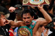 LAS VEGAS - NOVEMBER 14: Manny Pacquiao celebrates his 12 round TKO victory against Miguel Cotto during their WBO welterweight title fight at the MGM Grand Garden Arena on November 14, 2009 in Las Vegas, Nevada. (Photo by Ethan Miller/Getty Images)