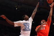 NEW YORK - NOVEMBER 20:  Arinze Onuaku #21 of the Syracuse Orange shoots against Ed Davis #32 of the North Carolina Tar Heels during the championship game of the 2K Sports Classic on November 20, 2009 at Madison Square Garden in New York City. The Orange defeated the Tar Heels 87-71 to win the championship.  (Photo by Jim McIsaac/Getty Images)