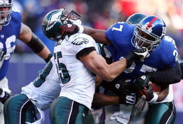 EAST RUTHERFORD, NJ - JANUARY 11:  Brandon Jacobs #27 of the New York Giants runs against Stewart Bradley #55 of the Philadelphia Eagles during the NFC Divisional Playoff Game on January 11, 2009 at Giants Stadium in East Rutherford, New Jersey.  (Photo by Al Bello/Getty Images)