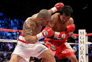 LAS VEGAS - NOVEMBER 14:  (L-R) Miguel Cotto of Puerto Rico throws a left to the head of Manny Pacquiao during their WBO welterweight title fight at the MGM Grand Garden Arena on November 14, 2009 in Las Vegas, Nevada.  (Photo by Al Bello/Getty Images)
