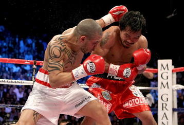 LAS VEGAS - NOVEMBER 14:  (L-R) Miguel Cotto of Puerto Rico throws a left to the head of Manny Pacquiao during their WBO welterweight title fight at the MGM Grand Garden Arena on November 14, 2009 in Las Vegas, Nevada.  (Photo by Al Bello/Getty Images)