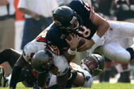 CHICAGO - SEPTEMBER 21: Quarterback Kyle Orton #18 of the Chicago Bears is is hit by Cato June #59 of the Tampa Bay Buccaneers at Soldier Field on September 21, 2008 in Chicago, Illinois. (Photo by Jonathan Ferrey/Getty Images)