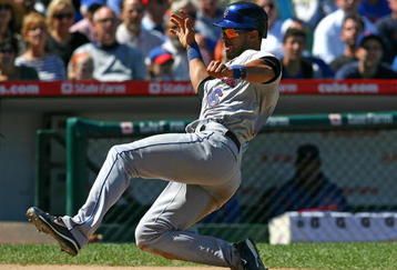 CHICAGO - AUGUST 30: Angel Pagan #16 of the New York Mets slides into home plate against the Chicago Cubs on August 30, 2009 at Wrigley Field in Chicago, Illinois. The Mets defeated the Cubs 4-1. (Photo by Jonathan Daniel/Getty Images)