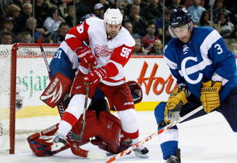 MONTREAL- NOVEMBER 21:  Tomas Holmstrom #96 of the Detroit Red Wings attempts to deflect the puck in front of Carey Price #31 and Ryan O'Byrne #3 of the Montreal Canadiens during the NHL game on November 21, 2009 at the Bell Centre in Montreal, Quebec, Canada.  The Red Wings defeated the Canadiens 3-2 in a shootout.  (Photo by Richard Wolowicz/Getty Images)