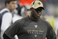 HOUSTON - AUGUST 22:  Running back Reggie Bush of the New Orleans Saints looks on from the sidelines against the Houston Texans on August 22, 2009 in Houston, Texas. An injured calf prevented him from playing.  (Photo by Bob Levey/Getty Images)