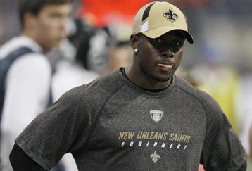 HOUSTON - AUGUST 22:  Running back Reggie Bush of the New Orleans Saints looks on from the sidelines against the Houston Texans on August 22, 2009 in Houston, Texas. An injured calf prevented him from playing.  (Photo by Bob Levey/Getty Images)