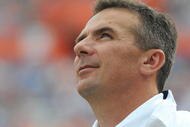 GAINESVILLE, FL - NOVEMBER 21: Coach Urban Meyer of the Florida Gators checks the scoreboard against the Florida International University Golden Panthers, November 21, 2009 at Ben Hill Griffin Stadium in Gainesville, Florida.  Florida won 62 - 3. (Photo by Al Messerschmidt/Getty Images)