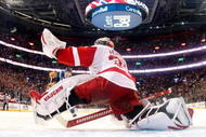 MONTREAL- NOVEMBER 21:  Jimmy Howard #35 of the Detroit Red Wings stretches out to stop the puck on the shootout attempt by Mike Cammalleri #13 of the Montreal Canadiens during the NHL game on November 21, 2009 at the Bell Centre in Montreal, Quebec, Canada.  The Red Wings defeated the Canadiens 3-2 in a shootout.  (Photo by Richard Wolowicz/Getty Images)