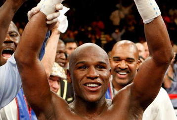 LAS VEGAS - SEPTEMBER 19:  Floyd Mayweather Jr., with his advisor Leonard Ellerbe behind him, celebrates his unanimous-decision victory over Juan Manuel Marquez at the MGM Grand Garden Arena September 19, 2009 in Las Vegas, Nevada.  (Photo by Ethan Miller/Getty Images)