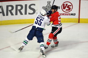 CHICAGO - MAY 05:  Shane O'Brien #55 of the Vancouver Canucks checks Ben Eager #55 of the Chicago Blackhawks during the first period of Game Three of the Western Conference Semifinal Round of the 2009 Stanley Cup Playoffs on May 5, 2009 at the United Center in Chicago, Illinois  (Photo by Jonathan Daniel/Getty Images)