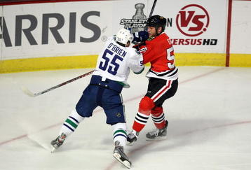 CHICAGO - MAY 05:  Shane O'Brien #55 of the Vancouver Canucks checks Ben Eager #55 of the Chicago Blackhawks during the first period of Game Three of the Western Conference Semifinal Round of the 2009 Stanley Cup Playoffs on May 5, 2009 at the United Center in Chicago, Illinois  (Photo by Jonathan Daniel/Getty Images)