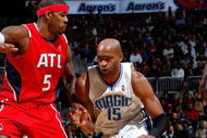 ATLANTA - NOVEMBER 26:  Vince Carter #15 of the Orlando Magic against Josh Smith #5 of the Atlanta Hawks at Philips Arena on November 26, 2009 in Atlanta, Georgia.  NOTE TO USER: User expressly acknowledges and agrees that, by downloading and/or using this Photograph, User is consenting to the terms and conditions of the Getty Images License Agreement.  (Photo by Kevin C. Cox/Getty Images)