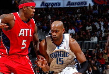 ATLANTA - NOVEMBER 26:  Vince Carter #15 of the Orlando Magic against Josh Smith #5 of the Atlanta Hawks at Philips Arena on November 26, 2009 in Atlanta, Georgia.  NOTE TO USER: User expressly acknowledges and agrees that, by downloading and/or using this Photograph, User is consenting to the terms and conditions of the Getty Images License Agreement.  (Photo by Kevin C. Cox/Getty Images)