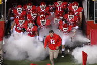 PISCATAWAY, NJ - NOVEMBER 12:  Head coach Greg Schiano of the Rutgers Scarlet Knights leads his team on the field to play against the South Florida Bulls at Rutgers Stadium on November 12, 2009 in Piscataway, New Jersey.  (Photo by Jim McIsaac/Getty Images)