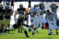 BOULDER, CO - OCTOBER 31: Wide reciever Danario Alexander #81 of the Missouri Tigers eludes safety Ray Polk #26 of the Colorado Buffaloes and goes 73 yards for a first quarter touchdown reception at Folsom Field on October 31, 2009 in Boulder, Colorado. (Photo by Doug Pensinger/Getty Images)