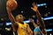 LOS ANGELES, CA - DECEMBER 01:  Kobe Bryant #24 of the Los Angeles Lakers goes in for a layup around Emeka Okafor #50 of the New Orleans Hornets during the first half at Staples Center on December 1, 2009 in Los Angeles, California. NOTE TO USER: User expressly acknowledges and agrees that, by downloading and/or using this Photograph, user is consenting to the terms and conditions of the Getty Images License Agreement.  (Photo by Harry How/Getty Images)
