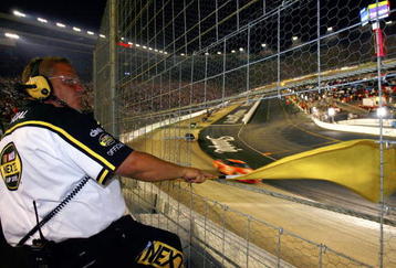 BRISTOL, TN - AUGUST 26:  A NASCAR official waves the yellow flag during a caution period, during the NASCAR Nextel Cup Series Sharpie 500 on August 26, 2006 at Bristol Motor Speedway in Bristol, Tennessee.  (Photo by Rusty Jarrett/Getty Images for NASCAR)
