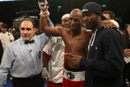 PHILADELPHIA - DECEMBER 02:  Bernard Hopkins (C) celebrates a win against Enrique Ornelas of Mexico with Philadelpia Eagles player Michael Vick (R) in Light Heavyweight bout on December 2, 2009 at The Liacouras Center in Philadelphia, Pennsylvania.  (Photo by Nick Laham/Getty Images)