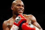 LAS VEGAS - SEPTEMBER 19:  Floyd Mayweather Jr. smiles in the ring during his fight against Juan Manuel Marquez at the MGM Grand Garden Arena September 19, 2009 in Las Vegas, Nevada. Mayweather won by unanimous decision.  (Photo by Ethan Miller/Getty Images)