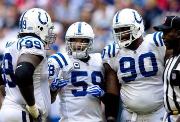 HOUSTON - NOVEMBER 29: Defensive tackles Antonio Johnson #99 and Daniel Muir #90 chat with linebacker Ramon Humber #59 of the Indianapolis Colts chat during a time out against the Houston Texans at Reliant Stadium on November 29, 2009 in Houston, Texas.  (Photo by Bob Levey/Getty Images)