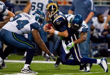 ST. LOUIS - NOVEMBER 29:  David Hawthorne #57 of the Seattle Seahawks sacks Kyle Boller #12 of the St. Louis Rams at the Edward Jones Dome on November 29, 2009 in St. Louis, Missouri.  The Seahawks beat the Rams 27-17.  (Photo by Dilip Vishwanat/Getty Images)