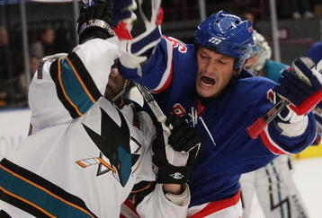 NEW YORK - OCTOBER 19: Dan Boyle #22 of the San Jose Sharks gets tied up with Sean Avery #16 of the New York Rangers at Madison Square Garden on October 19, 2009 in New York City.  (Photo by Bruce Bennett/Getty Images)