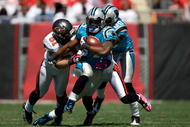 TAMPA, FL - OCTOBER 18:  Running back DeAngelo Williams #34 of the Carolina Panthers is tackled by defenders Barrett Ruud #51 and Ronde Barber #20 of the Tampa Bay Buccaneers during the game at Raymond James Stadium on October 18, 2009 in Tampa, Florida.  (Photo by J. Meric/Getty Images)