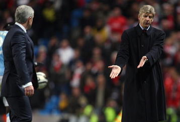 MANCHESTER, ENGLAND - DECEMBER 02:  Man City manager Mark Hughes (l) and Arsene Wenger have words during the Carling Cup quarter final match between Manchester City and Arsenal at City of Manchester stadium on December 2, 2009 in Manchester, England.  (Photo by Stu Forster/Getty Images)