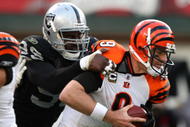 OAKLAND, CA - NOVEMBER 22: Carson Palmer #9 of the Cincinnati Bengals is sacked by Greg Ellis #99 of the Oakland Raiders during an NFL game at Oakland-Alameda County Coliseum on November 22, 2009 in Oakland, California. (Photo by Jed Jacobsohn/Getty Images)