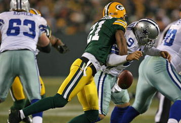 GREEN BAY, WI - NOVEMBER 15: Charles Woodson #21 of the Green Bay Packers hits Tony Romo #9 of the Dallas Cowboys forcing a fumble at Lambeau Field on November 15, 2009 in Green Bay, Wisconsin. The Packers defeated the Cowboys 17-7. (Photo by Jonathan Daniel/Getty Images)