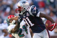 FOXBORO, MA - NOVEMBER 8:  Randy Moss #81 of the New England Patriots gains yards against the defense of Vontae Davis of the Miami Dolphins at Gillette Stadium on November 8, 2009 in Foxboro, Massachusetts. The Patriots won 27-17. (Photo by Jim Rogash/Getty Images)