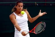 WIMBLEDON, ENGLAND - JUNE 27: Amelie Mauresmo of France plays a backhand during the women's singles third round match against Flavia Pennetta of Italy on Day Six of the Wimbledon Lawn Tennis Championships at the All England Lawn Tennis and Croquet Club on June 27, 2009 in London, England. (Photo by Ian Walton/Getty Images)