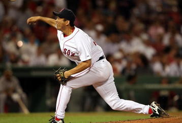 BOSTON - JULY 06:  Takashi Saito #24 of the Boston Red Sox delivers a pitch against the Oakland Athletics on July 6, 2009 at Fenway Park in Boston, Massachusetts. The Athletics defeated the Red Sox 6-0.  (Photo by Elsa/Getty Images)