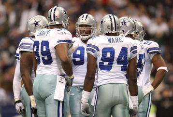 IRVING, TX - DECEMBER 20:  DeMarcus Ware #94 of the Dallas Cowboys huddles together with his defensive line during their NFL game against the Baltimore Ravens at Texas Stadium on December 20, 2008 in Irving, Texas. The Ravens defeated the Cowboys 33-24. (Photo by Ronald Martinez/Getty Images)