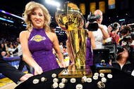 LOS ANGELES, CA - OCTOBER 27:  A member of the Laker Girls poses with the Larry O'Brien championship trophy and rings to be presented to the Los Angeles Lakers before the season opening game against the Los Angeles Clippers at Staples Center on October 27, 2009 in Los Angeles, California.  NOTE TO USER: User expressly acknowledges and agrees that, by downloading and or using this photograph, User is consenting to the terms and conditions of the Getty Images License Agreement. Mandatory Copyright Notice: Copyright 2009 NBAE  (Photo by Kevork Djansezian/Getty Images)