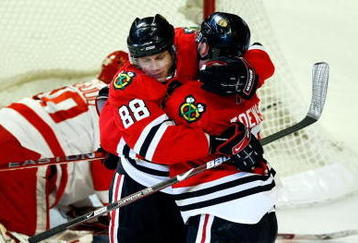 CHICAGO - MAY 24:  Patrick Kane #88 and Jonathan Toews #19 of the Chicago Blackhawks celebrate after Toews scored a goal in the second period against goalie Chris Osgood #30 of the Detroit Red Wings during Game Four of the Western Conference Championship Round of the 2009 Stanley Cup Playoffs on May 24, 2009 at the United Center in Chicago, Illinois.  (Photo by Jim Prisching/Getty Images)