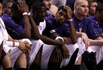 PORTLAND, OR - MARCH 21:  (L) Venoy Overton #1 of the Washington Huskies along with the rest of the Huskies bench react late in the second half before losing to the Purdue Boilermakers during the second round of the NCAA Division I Men's Basketball Tournament at the Rose Garden on March 21, 2009 in Portland, Oregon. The Boilermakers defeated the Huskies 76-74 to advance to the Sweet 16.  (Photo by Jonathan Ferrey/Getty Images)