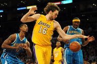 LOS ANGELES, CA - DECEMBER 01: Pau Gasol #16 of the Los Angeles Lakers controls a rebound in front of James Posey #41 and Hilton Armstrong #12 of the New Orleans Hornets at Staples Center on December 1, 2009 in Los Angeles, California. (Photo by Harry How/Getty Images) NOTE TO USER: User expressly acknowledges and agrees that, by downloading and/or using this Photograph, user is consenting to the terms and conditions of the Getty Images License Agreement.