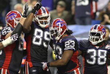 TORONTO - DECEMBER 3: Geoff Hangartner #63, Shawn Nelson #89, Marshawn Lynch #23 and Corey McIntyre #38 of the Buffalo Bills celebrate after Lynch scored a 15-yard rushing touchdown in the second quarter against the New York Jets at Rogers Centre on December 3, 2009 in Toronto, Canada.  (Photo by Rick Stewart/Getty Images)