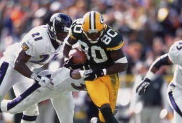 14 Oct 2001:  Donald Driver #80 of the Green Bay Packers gets tackled by Chris McAllister #21 and James Trapp #38 of the Baltimore Ravens during the game at Lambeau Field in Green Bay, Wisconsin. The Packers defeated the Ravens 31-23.Mandatory Credit: Harry How  /Allsport