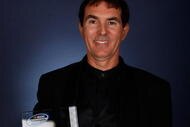MIAMI - NOVEMBER 23: Driver Mike Bliss poses after being awarded the 2009 NASCAR Nationwide Series 5th place driver trophy during the NASCAR Nationwide/Truck Series Banquet at Loews Miami Beach Hotel on November 23, 2009 in Miami, Florida. (Photo by Chris Graythen/Getty Images for NASCAR)