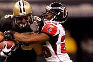 NEW ORLEANS - NOVEMBER 02:  David Thomas #85 of the New Orleans Saints runs for a first down against Erik Coleman #26 of the Atlanta Falcons during the first quarter of the game at the Louisiana Superdome on November 2, 2009 in New Orleans, Louisiana.(Photo by Chris Graythen/Getty Images)