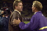 SEATTLE - SEPTEMBER 21: Head coach Rick Neuheisel of the Washington Huskies accepts congratulations from head coac Vic Koenning of the Wyoming Cowboys after the NCAA football game on September 21, 2002 at Husky Stadium in Seattle, Washington. The Huskies won 38-7. (Photo by Otto Greule Jr/Getty Images)