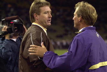 SEATTLE - SEPTEMBER 21:  Head coach Rick Neuheisel of the Washington Huskies accepts congratulations from head coac Vic Koenning of the Wyoming Cowboys after the NCAA football game on September 21, 2002 at Husky Stadium in Seattle, Washington.  The Huskies won 38-7.  (Photo by Otto Greule Jr/Getty Images)