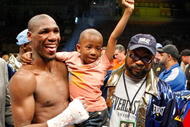 LAS VEGAS - APRIL 11:  Paul Williams holds his son Paul Williams Jr. as he and his trainer George Peterson celebrate defeating Winky Wright in a unanimous decision in their middleweight bout at the Mandalay Bay Events Center April 11, 2009 in Las Vegas, Nevada.  (Photo by Ethan Miller/Getty Images)