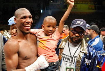 LAS VEGAS - APRIL 11:  Paul Williams holds his son Paul Williams Jr. as he and his trainer George Peterson celebrate defeating Winky Wright in a unanimous decision in their middleweight bout at the Mandalay Bay Events Center April 11, 2009 in Las Vegas, Nevada.  (Photo by Ethan Miller/Getty Images)