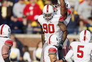 ANN ARBOR, MI - NOVEMBER 21: Thaddeus Gibson #90 of the Ohio State Buckeyes celebrates a fourth quarter interception with teammates while playing the Michigan Wolverines on November 21, 2009 at Michigan Stadium in Ann Arbor, Michigan. Ohio State won the game 21-10. (Photo by Gregory Shamus/Getty Images)