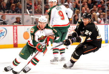 ANAHEIM, CA - OCTOBER 14:  Marek Zidlicky #3 of the Minnesota Wild circles as he is chased by Evgeny Artyukhin #24 of the Anaheim Ducks as Mikko Koivu waits for a pass during the game at the Honda Center on October 14, 2009 in Anaheim, California.  (Photo by Harry How/Getty Images)